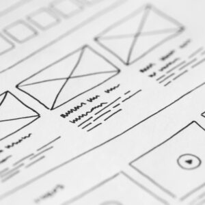 Detailed close-up of a hand-drawn wireframe design on paper for a UX project.